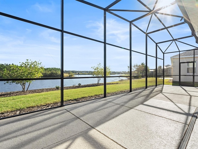 unfurnished sunroom featuring a water view