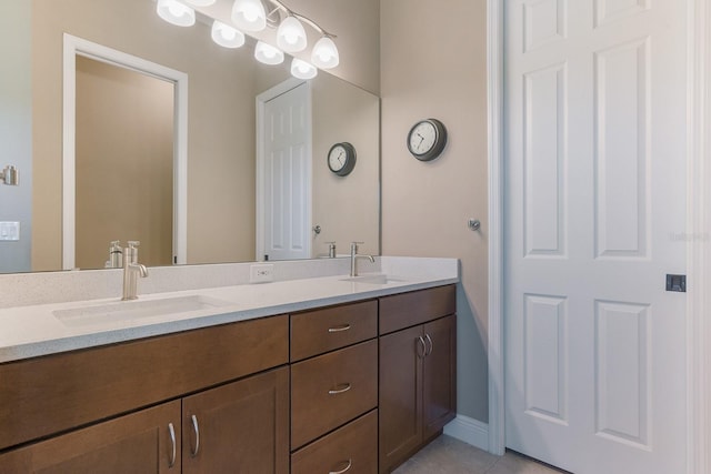 bathroom featuring tile patterned flooring and vanity