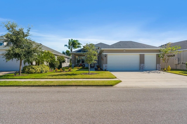 single story home featuring a garage and a front lawn