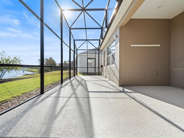 unfurnished sunroom with a water view