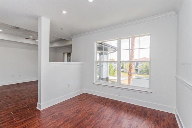 spare room featuring crown molding and dark wood-type flooring