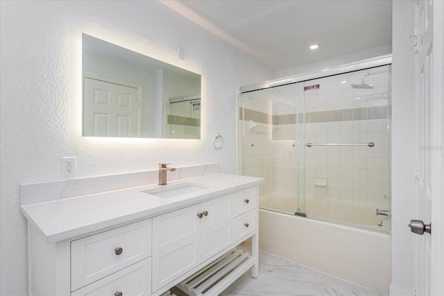 bathroom featuring vanity and shower / bath combination with glass door