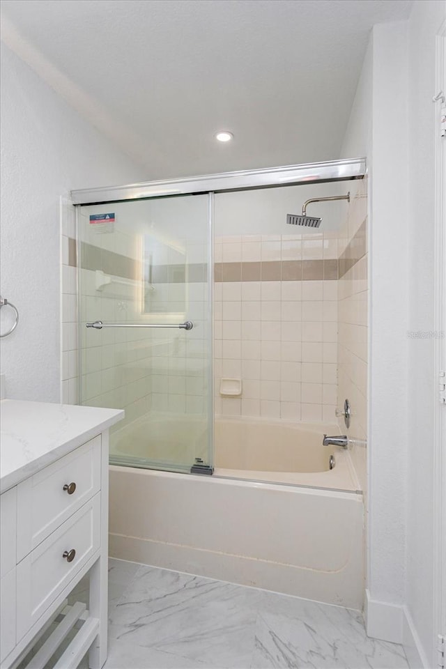 bathroom with vanity and bath / shower combo with glass door