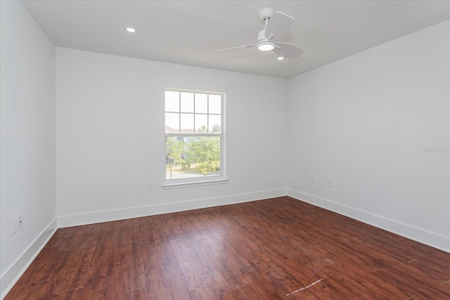 unfurnished room featuring ceiling fan and dark wood-type flooring