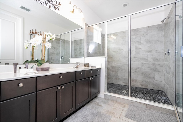 bathroom featuring vanity and a shower with shower door