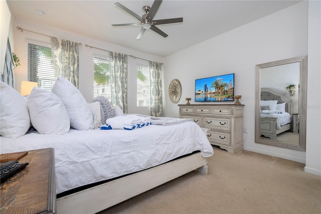 bedroom with light carpet, multiple windows, and ceiling fan