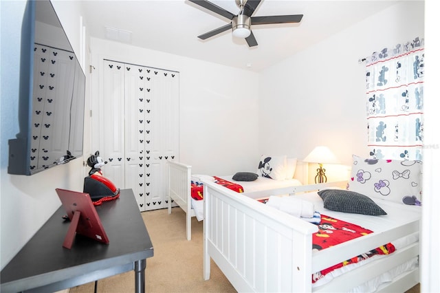 bedroom featuring light colored carpet and ceiling fan