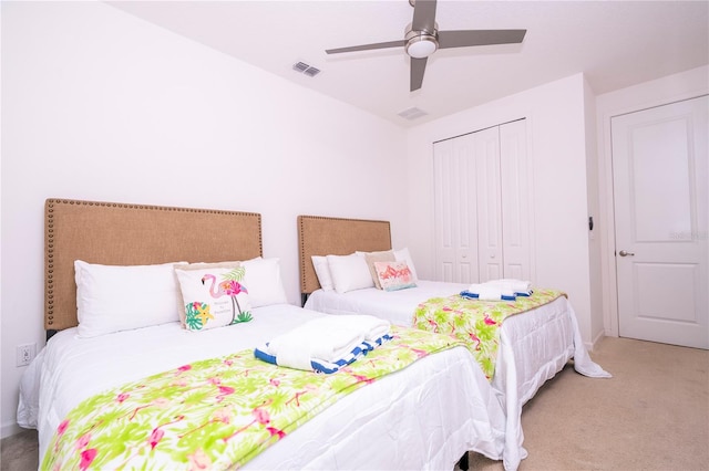 bedroom with light carpet, a closet, and ceiling fan