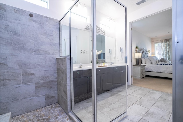 bathroom featuring vanity and tiled shower