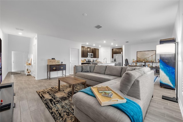 1093 Berry Ln, Davenport, FL 33837 - living room with wood tiled floors, recessed lighting, and baseboards