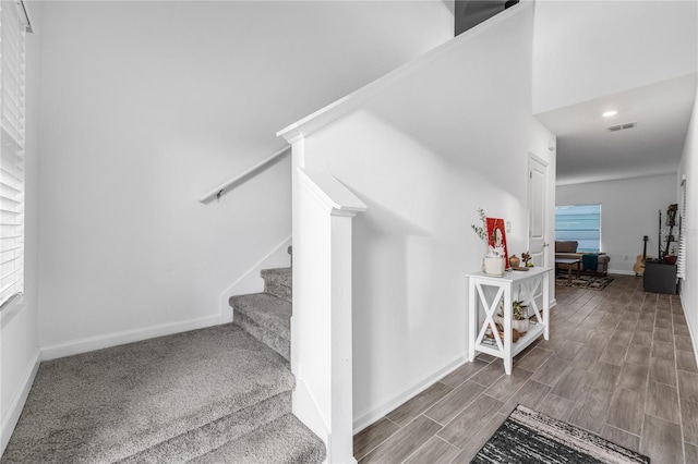 stairway with hardwood / wood-style floors