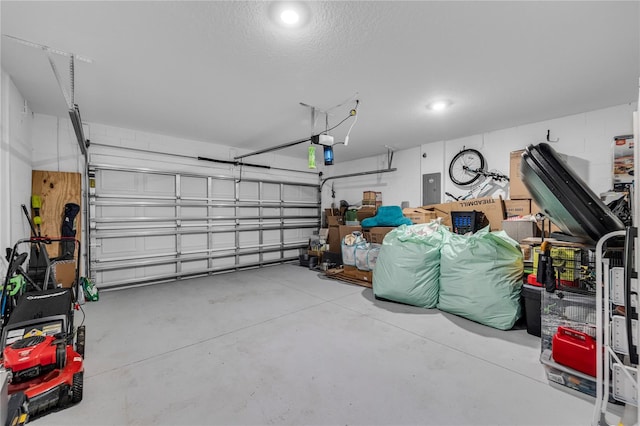 garage with a garage door opener and electric panel