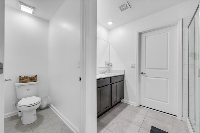 bathroom featuring vanity, tile patterned floors, toilet, and an enclosed shower