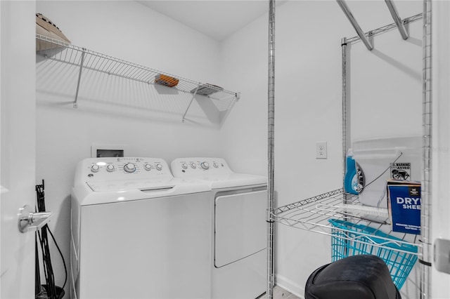 clothes washing area featuring separate washer and dryer