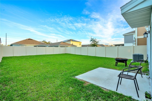 view of yard with a patio and central AC unit