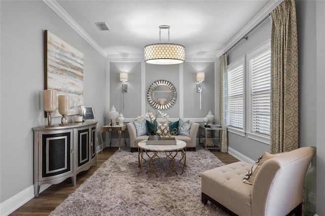 living area featuring baseboards, dark wood-style flooring, visible vents, and crown molding