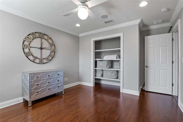 unfurnished bedroom with crown molding, a textured ceiling, visible vents, and dark wood-type flooring