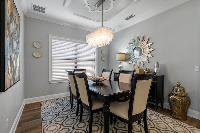 dining area featuring ornamental molding, visible vents, baseboards, and wood finished floors