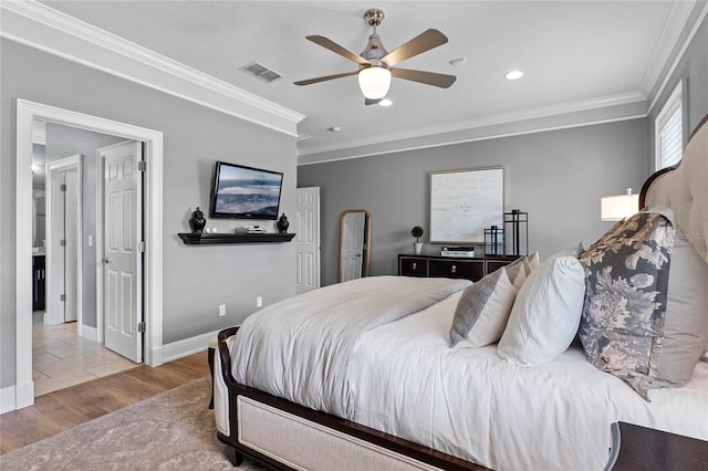 bedroom featuring visible vents, ornamental molding, ceiling fan, wood finished floors, and baseboards