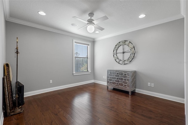 interior space featuring dark wood-style floors, ceiling fan, ornamental molding, and baseboards