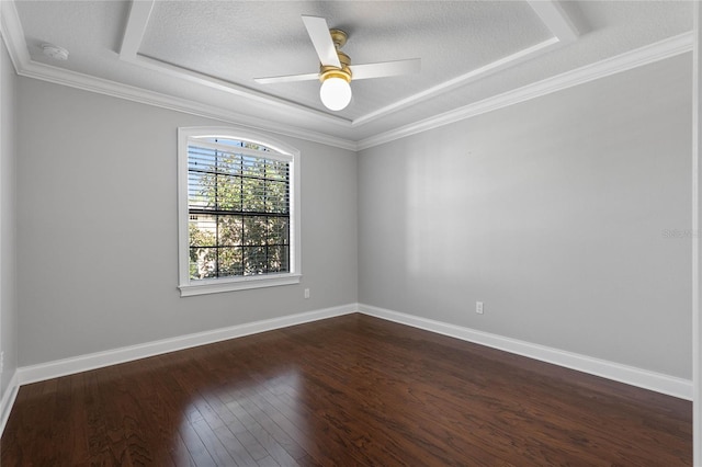 unfurnished room featuring baseboards, ceiling fan, dark wood-type flooring, a tray ceiling, and a textured ceiling