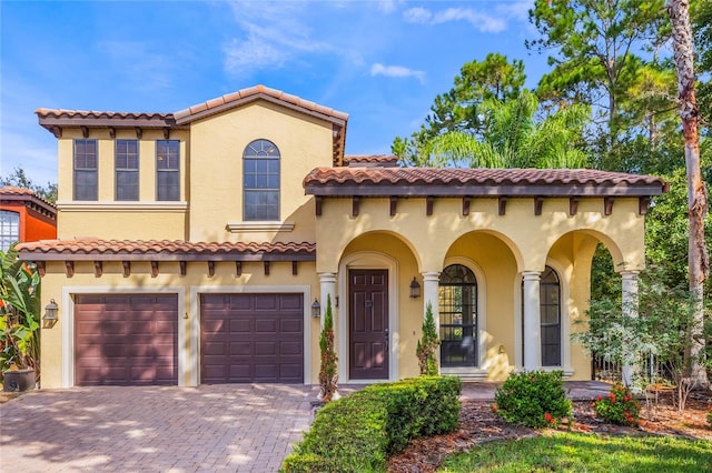 mediterranean / spanish-style home with a garage