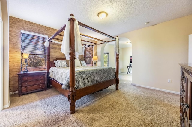 carpeted bedroom featuring a textured ceiling