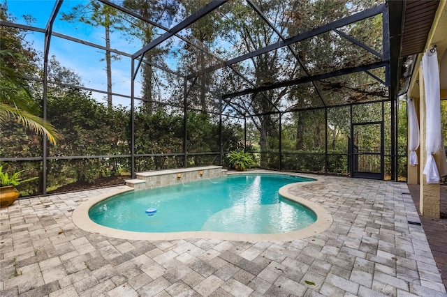 view of swimming pool featuring a patio area, pool water feature, and a lanai