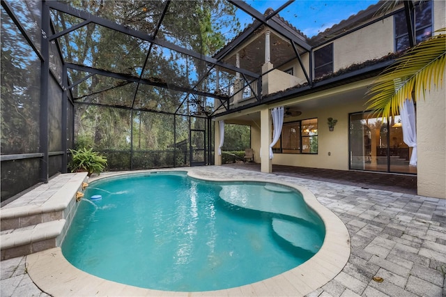 view of pool with a patio, pool water feature, and a lanai