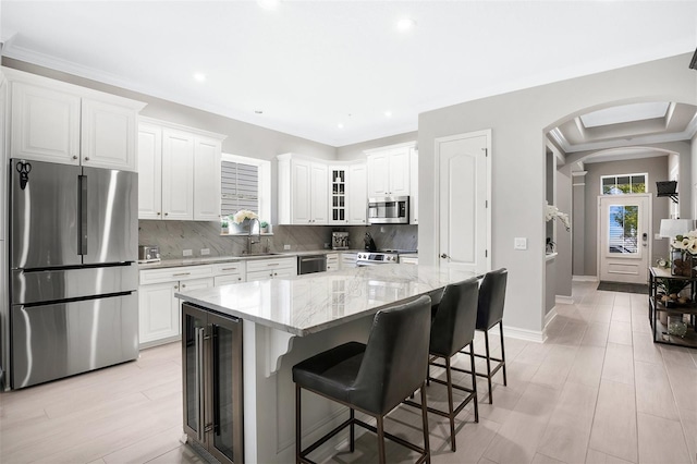 kitchen featuring appliances with stainless steel finishes, white cabinetry, and a kitchen island