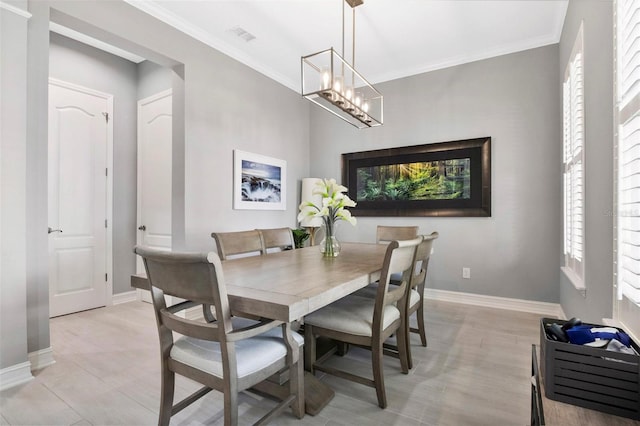 dining room featuring a notable chandelier, ornamental molding, and plenty of natural light