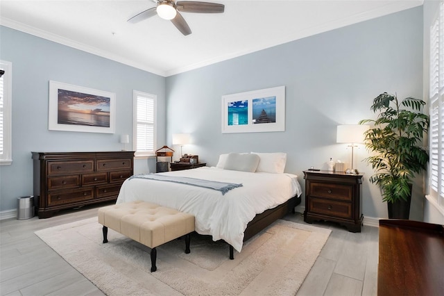 bedroom with ceiling fan, crown molding, and light wood-type flooring