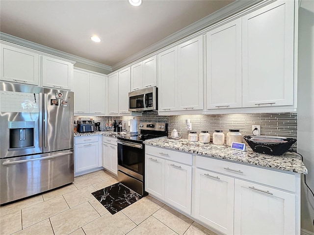 kitchen featuring light stone countertops, tasteful backsplash, white cabinetry, light tile patterned floors, and stainless steel appliances