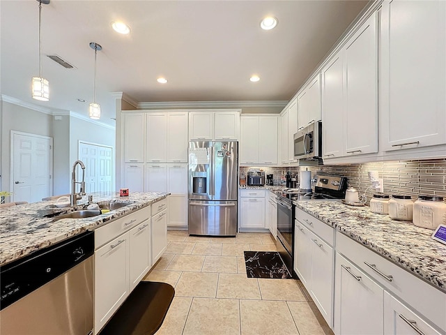 kitchen with hanging light fixtures, appliances with stainless steel finishes, sink, white cabinetry, and light tile patterned floors