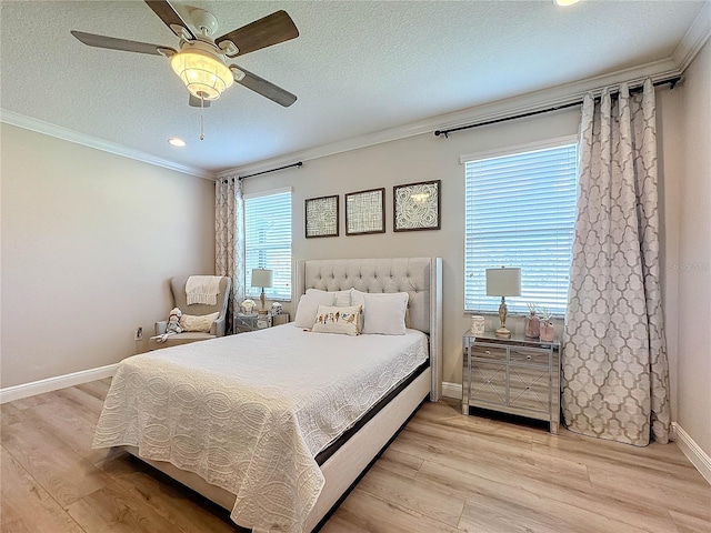 bedroom with ceiling fan, light hardwood / wood-style floors, and a textured ceiling