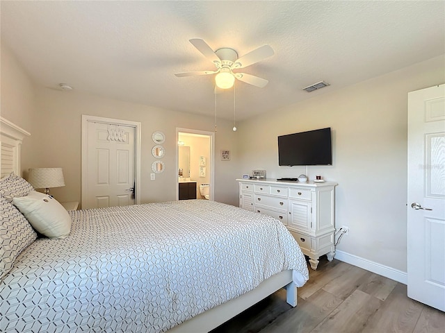 bedroom with ceiling fan, light hardwood / wood-style flooring, and a textured ceiling