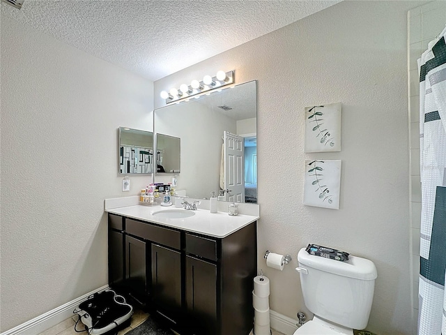 bathroom featuring a textured ceiling, toilet, vanity, and a shower with curtain