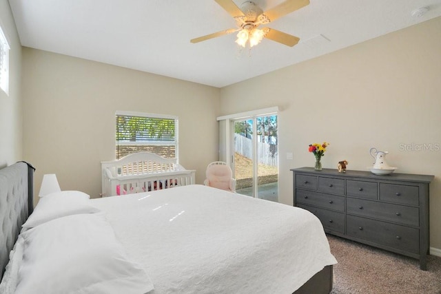 bedroom featuring light carpet, multiple windows, access to outside, and ceiling fan