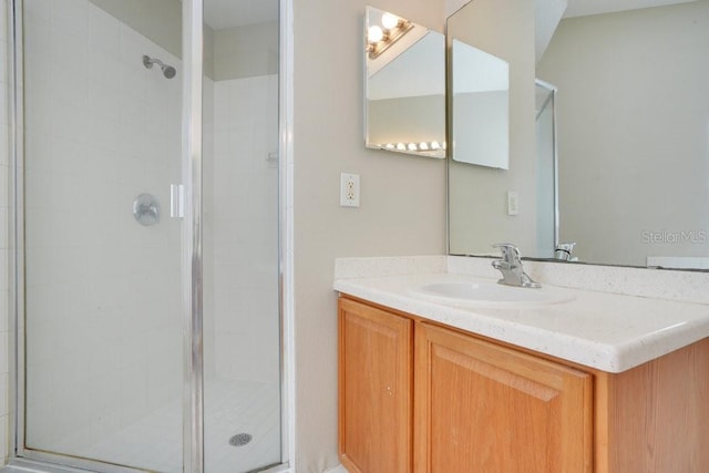 bathroom featuring vanity and an enclosed shower