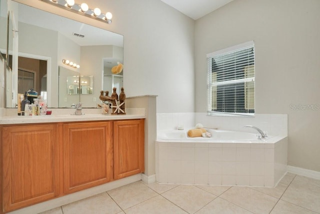 bathroom featuring vanity, tile patterned floors, and tiled bath