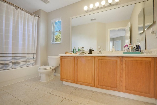 full bathroom with vanity, shower / bath combo with shower curtain, toilet, and tile patterned floors