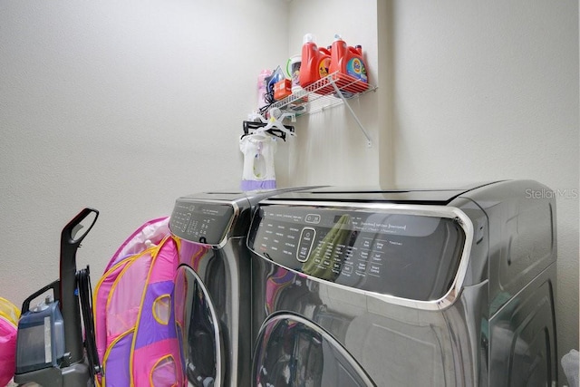 clothes washing area featuring independent washer and dryer