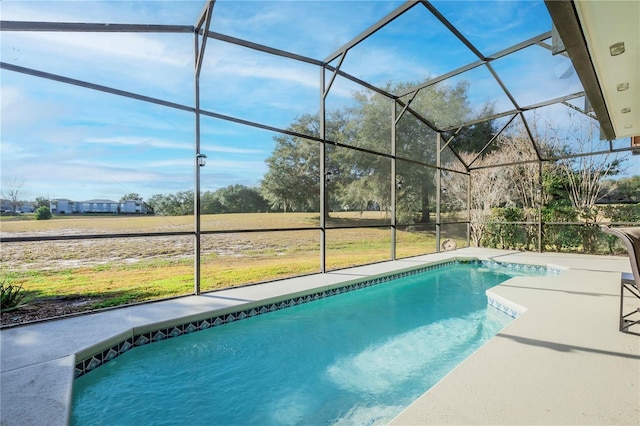 view of swimming pool with a patio and glass enclosure