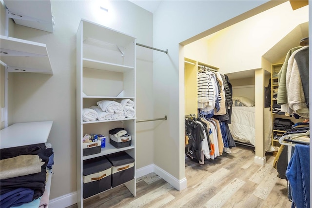 spacious closet with light hardwood / wood-style flooring