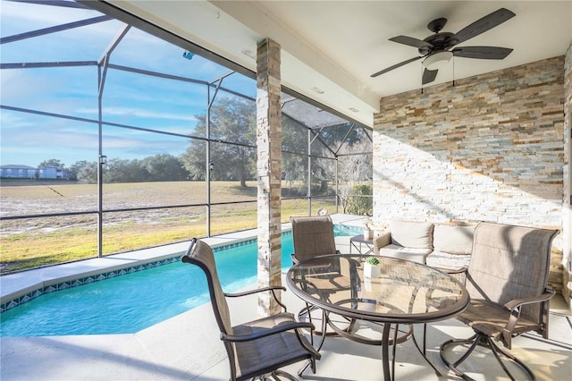 view of swimming pool featuring ceiling fan, a patio, and glass enclosure