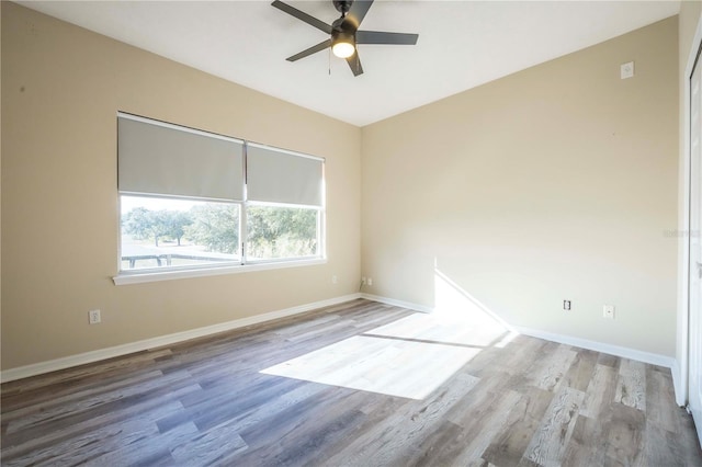 spare room featuring hardwood / wood-style flooring and ceiling fan