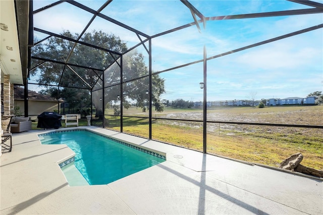 view of swimming pool with a lanai and a patio area