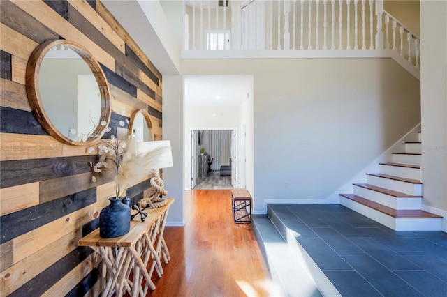 hallway with a high ceiling and wood walls