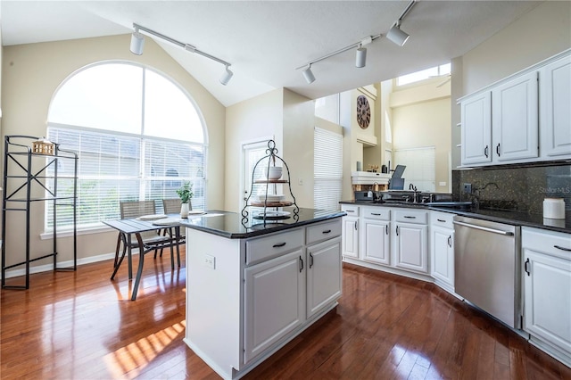 kitchen featuring dishwasher, white cabinets, dark hardwood / wood-style flooring, backsplash, and a center island