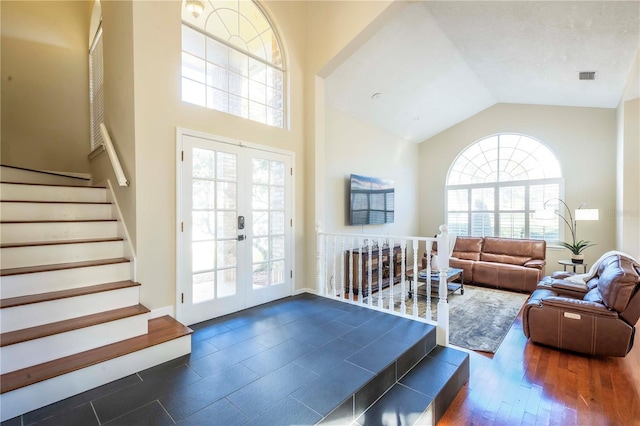 interior space featuring plenty of natural light, lofted ceiling, and french doors